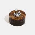 Round acrylic lighter container with silver metallic top on a white background Thumbnail